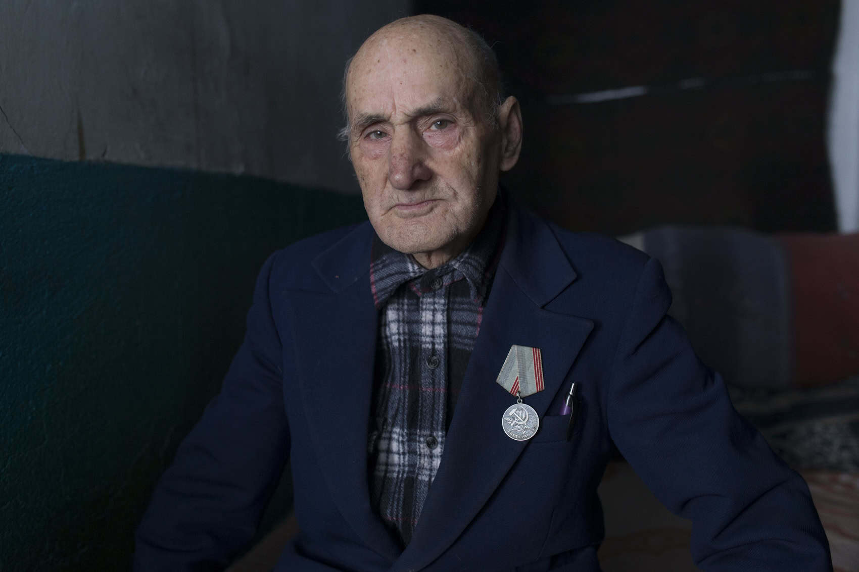 Alexandru, 81, with his Soviet medal for being a role model worker. Corpaci, Moldova. February 2018.