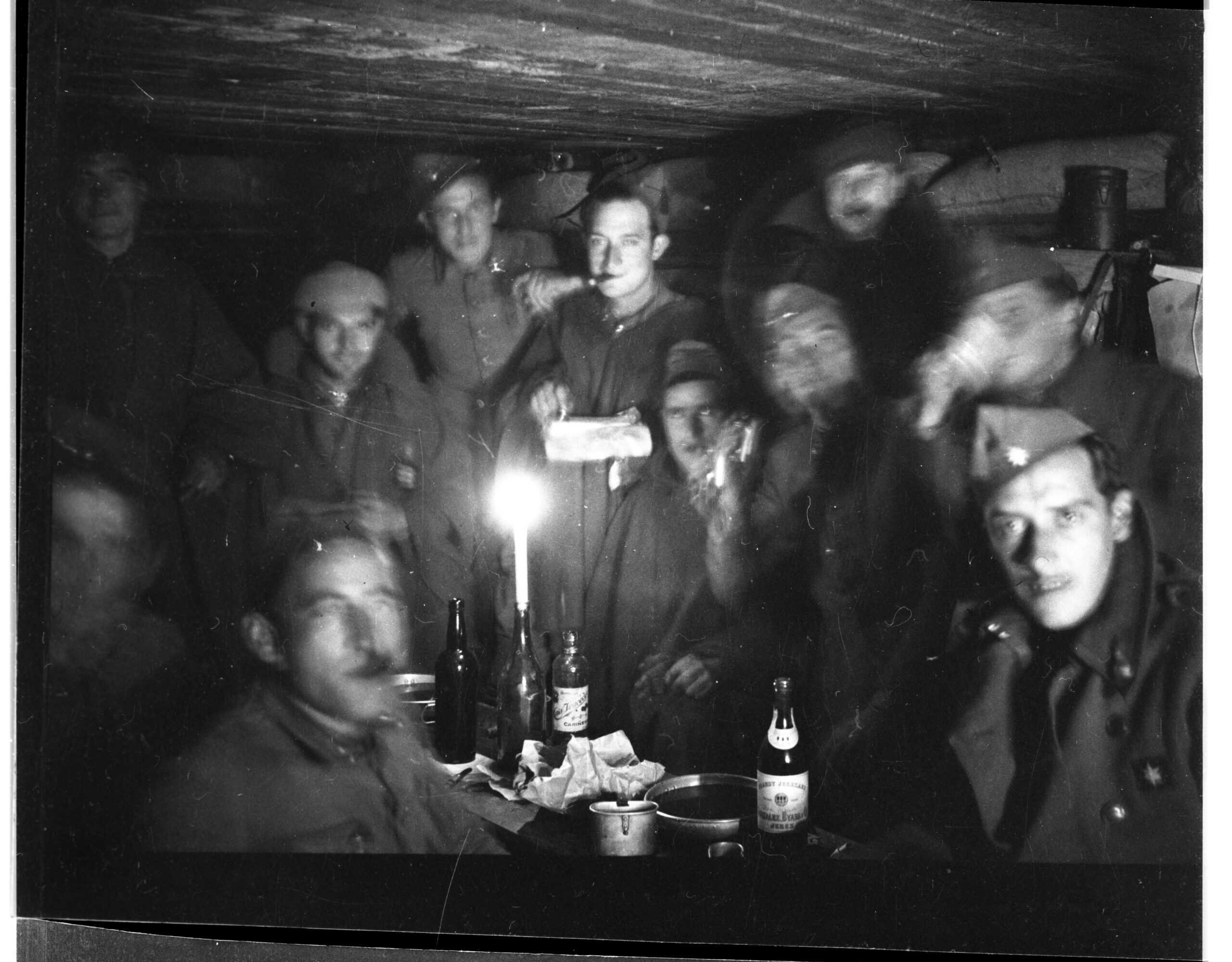 Republican soldiers celebrating Christmas by candlelight, frontline bunker near Fuentes de Ebro, 1937