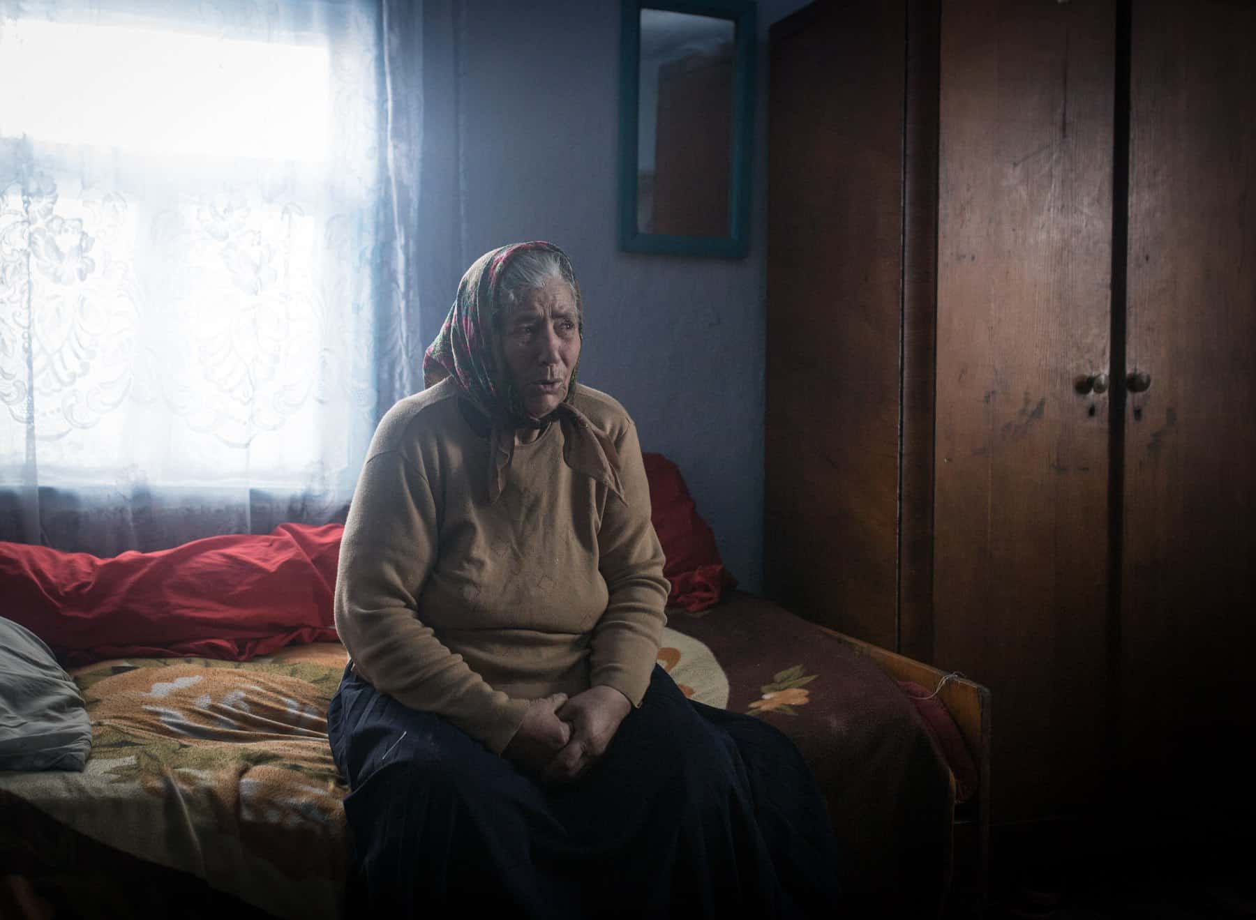 Zamfira, 75, in Făleștii Noi, Moldova. February 2018.